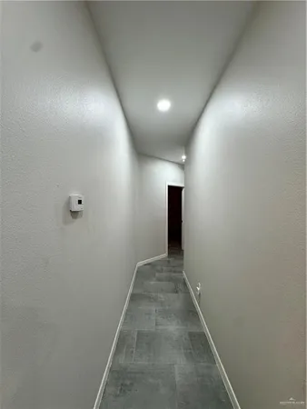 a bedroom with a bed and a lamp