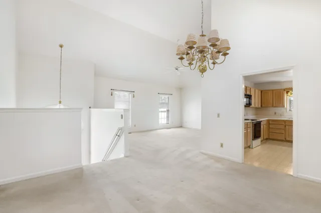 a view of a kitchen with a sink and a chandelier