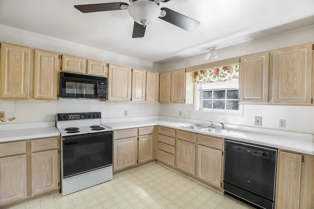 a kitchen with a sink stove and microwave