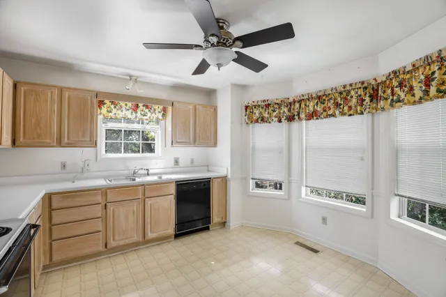 a spacious bathroom with a double vanity sink a mirror and a bathtub