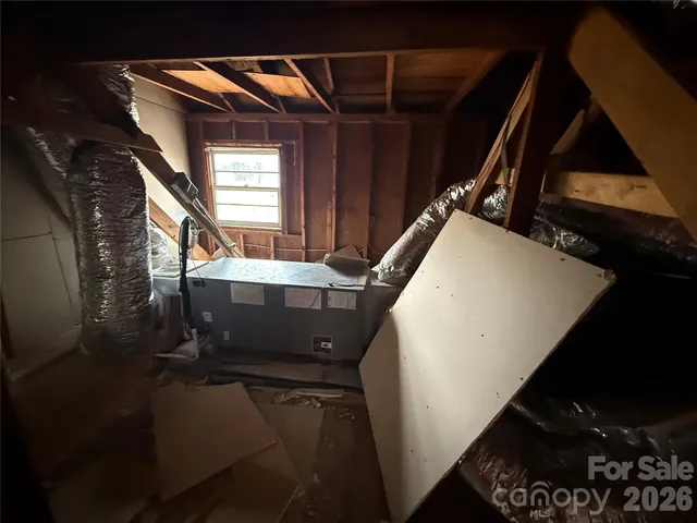 a view of a house with a large window and wooden fence