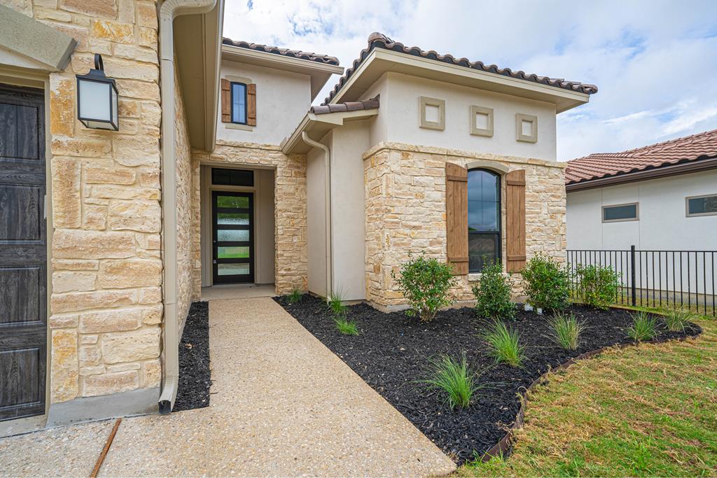 2013 Toscano Way Kerrville, TX 78028 - Photo 4 of 21 a front view of a house with garden