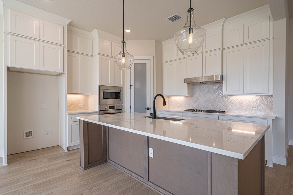 2013 Toscano Way Kerrville, TX 78028 - Photo 9 of 21 a kitchen with kitchen island a sink stainless steel appliances and cabinets