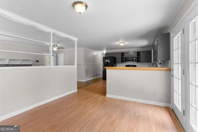 a view of a kitchen with wooden floor and electronic appliances