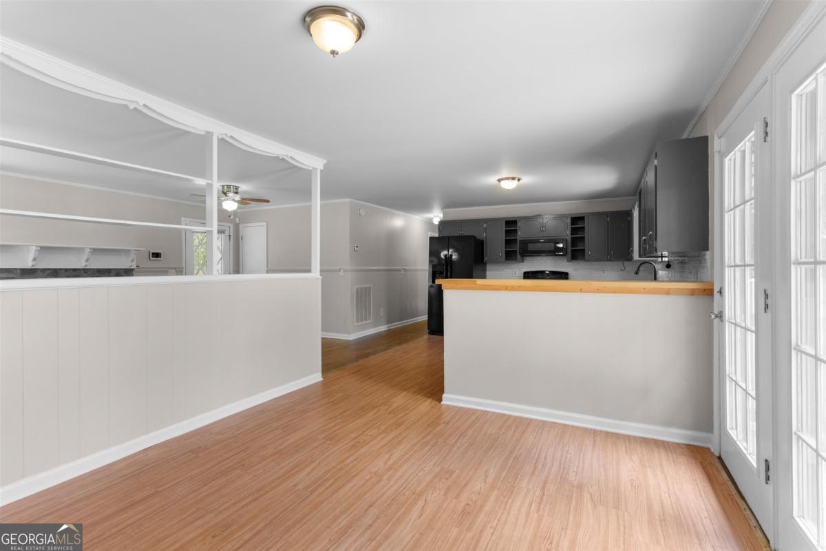 1251 Brickhouse Road Greensboro, GA 30642 - Photo 14 of 35 a view of a kitchen with wooden floor and electronic appliances