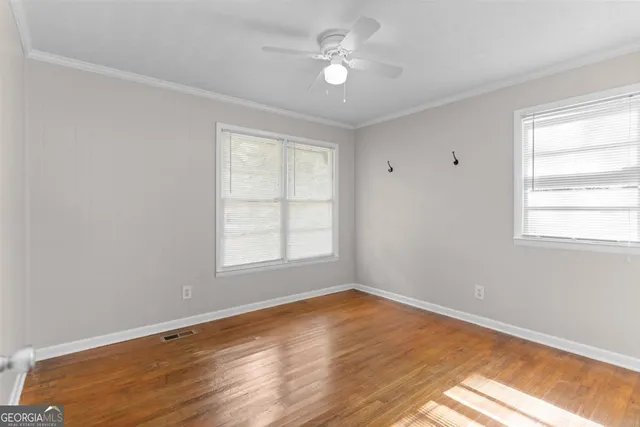 wooden floor in an empty room with a window