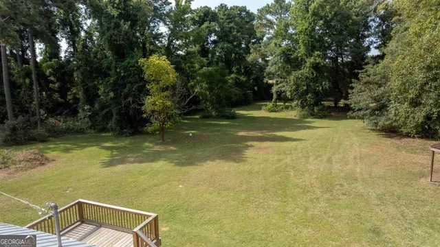 a view of a swimming pool with a yard