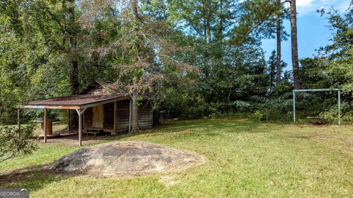 1251 Brickhouse Road Greensboro, GA 30642 - Photo 32 of 35 a view of house with backyard space and balcony