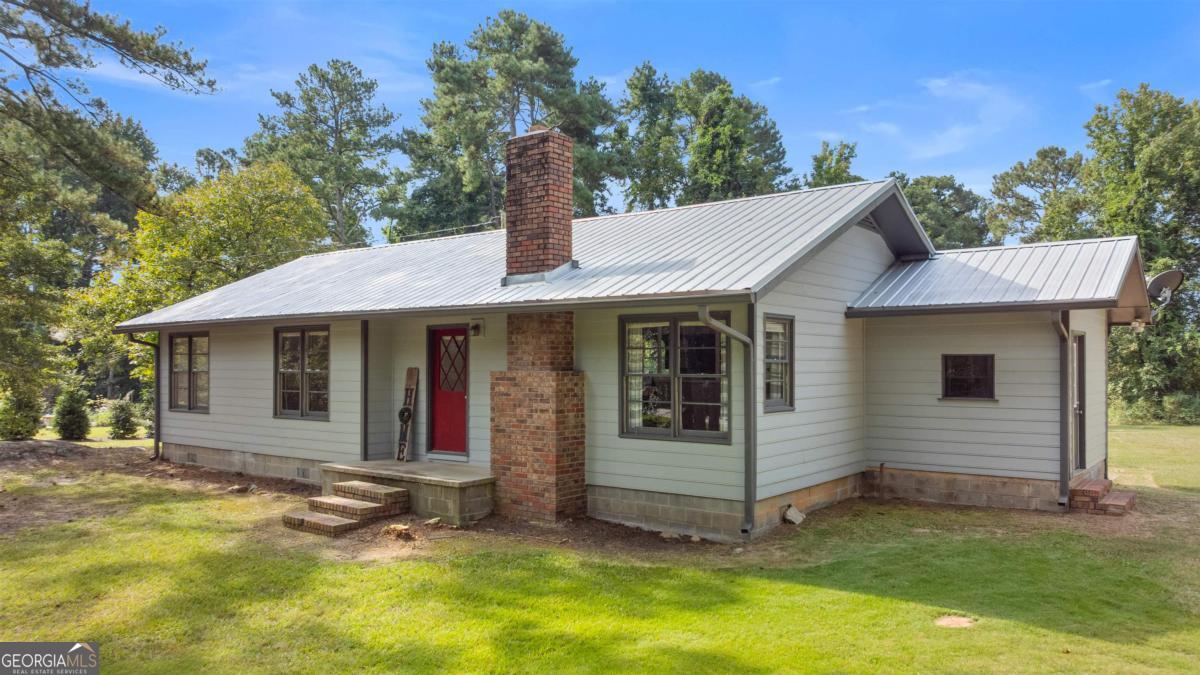 1251 Brickhouse Road Greensboro, GA 30642 - Photo 34 of 35 a view of a house with a yard and large tree