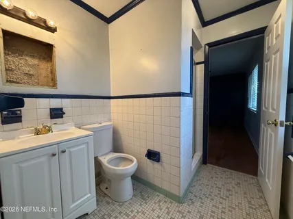 a bathroom with a toilet a sink and shower