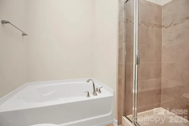 a white bath tub sitting next to a shower