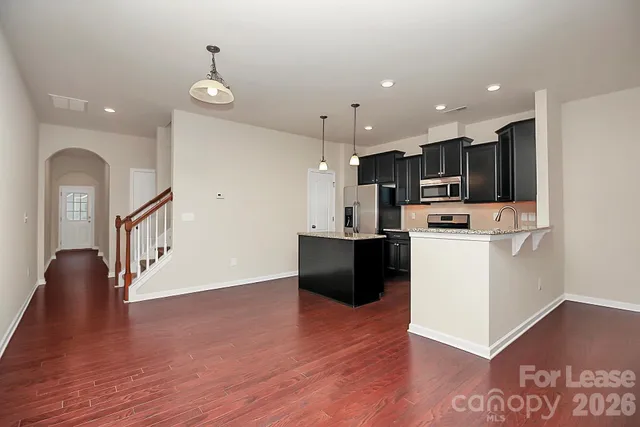 a view of kitchen with sink microwave and stove