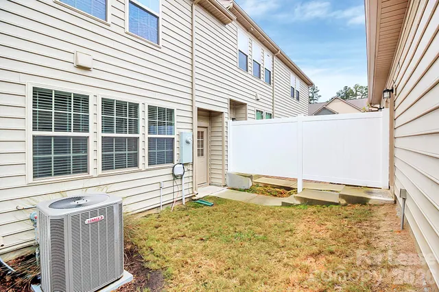 a view of a house with a backyard and a garage