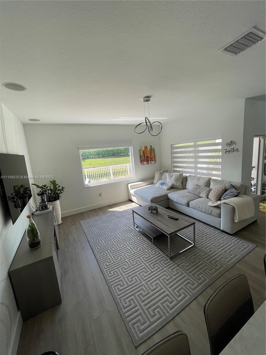 Doral Isles Doral, FL 33178 - Photo 11 of 35 a living room with furniture and a window