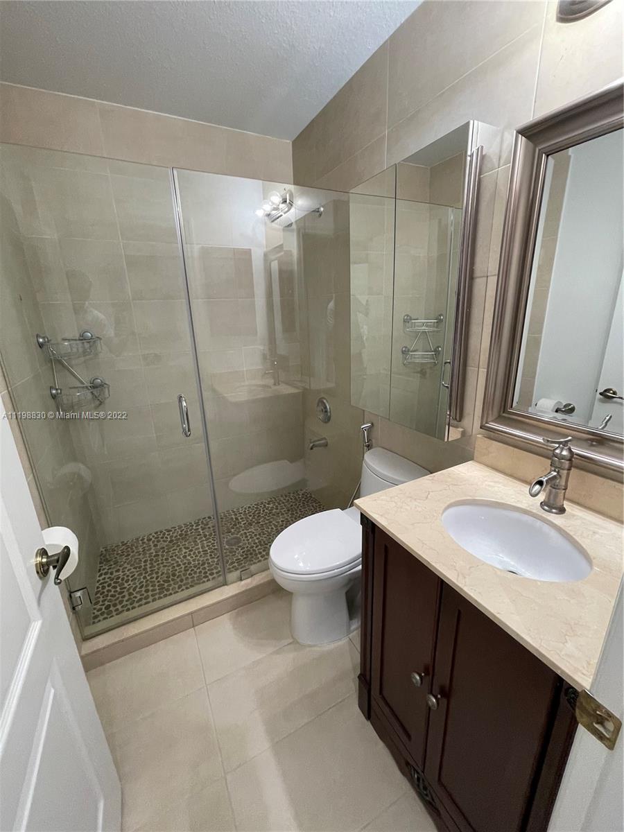 Doral Isles Doral, FL 33178 - Photo 26 of 35 a bathroom with a sink a toilet and shower