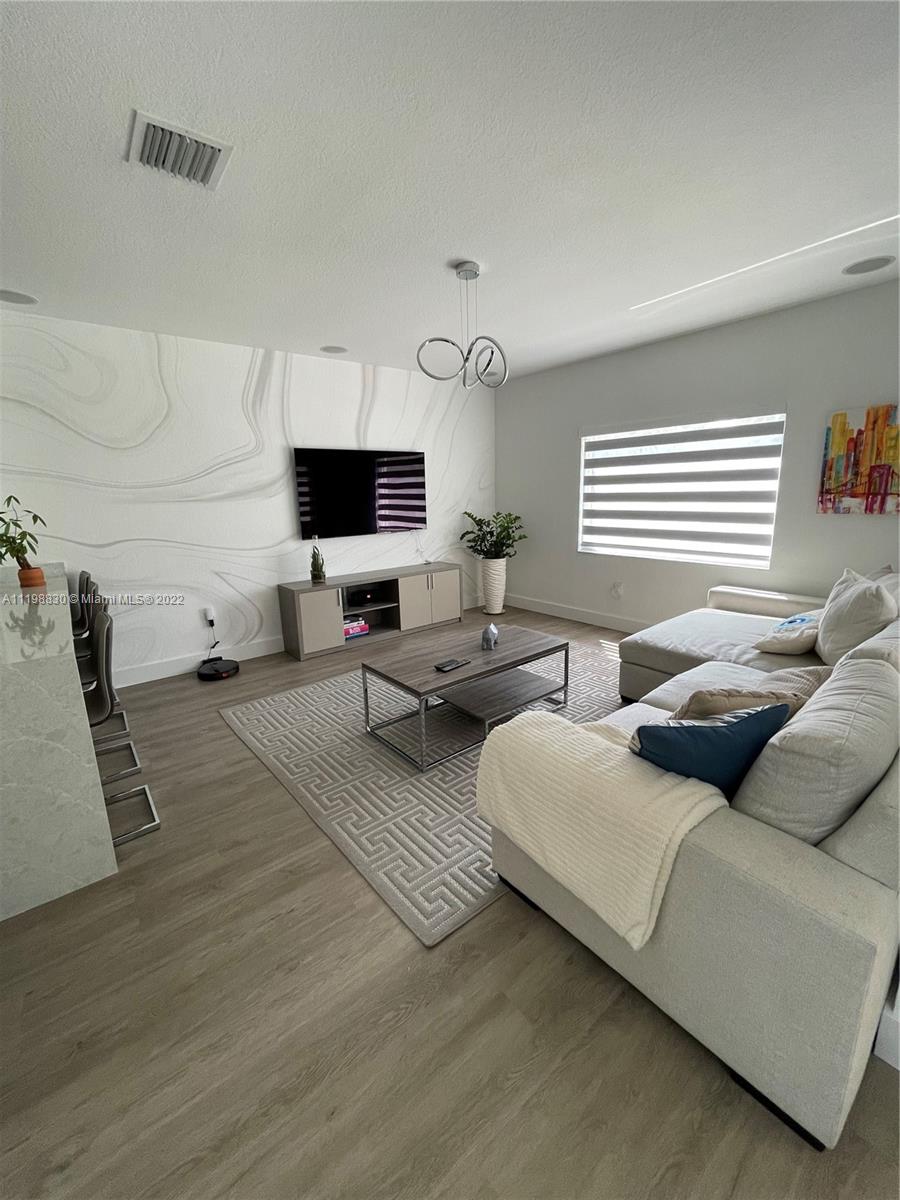 Doral Isles Doral, FL 33178 - Photo 7 of 35 a living room with couches and a flat screen tv