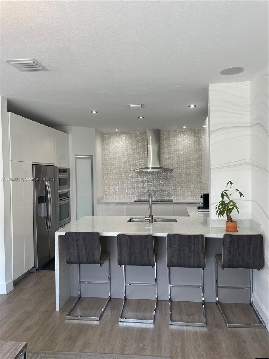 Doral Isles Doral, FL 33178 - Photo 8 of 35 a kitchen with a sink cabinets and stainless steel appliances