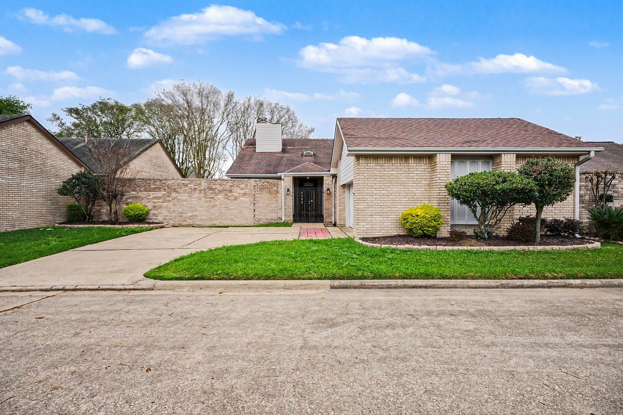 1723 Linfield Way Houston, TX 77058 - Photo 20 of 21 This charming single-story brick home features a neatly maintained front yard with trimmed bushes and a spacious driveway. The property exudes a welcoming suburban appeal.