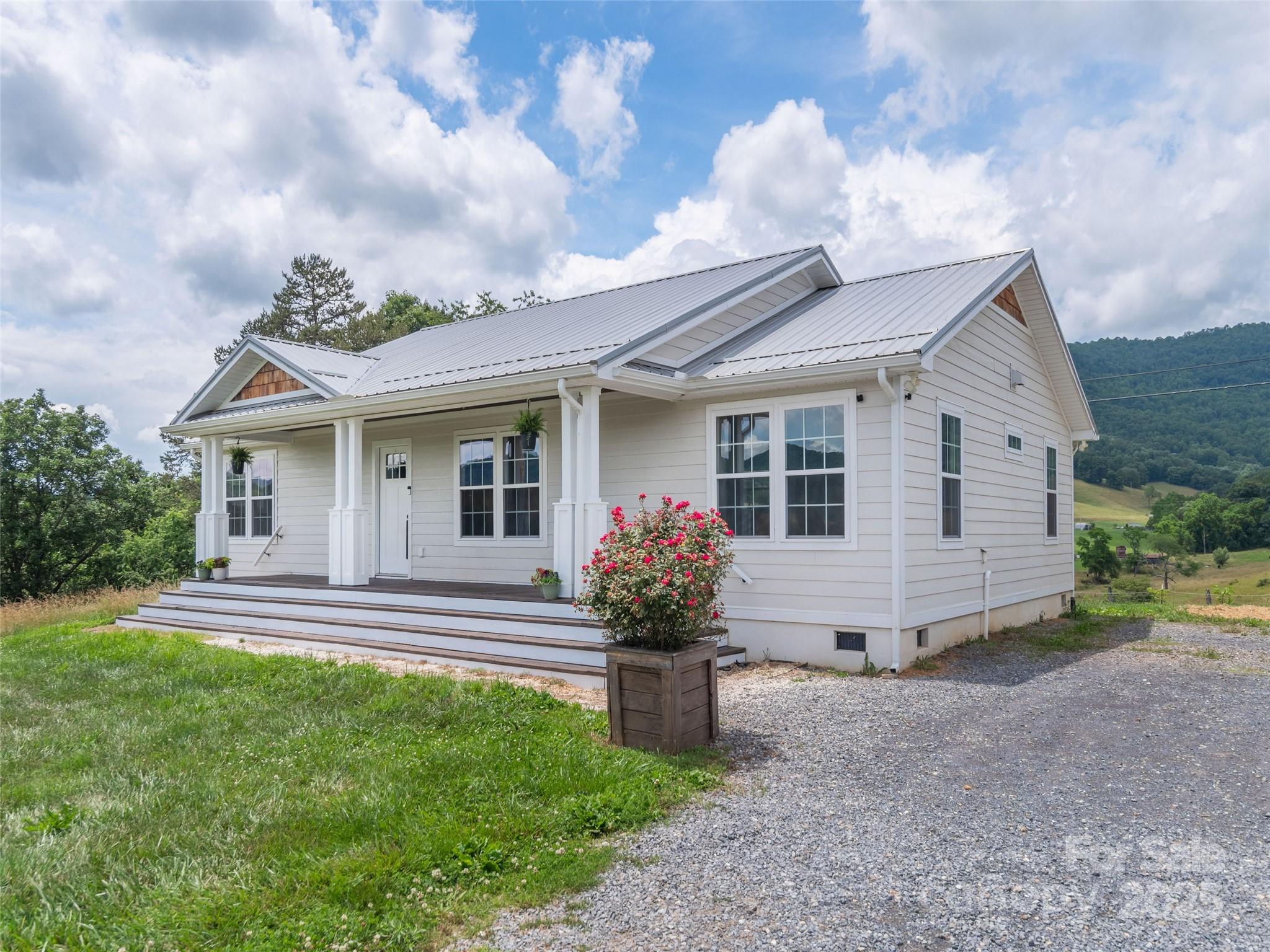 3355 Thickety Road Clyde, NC 28721 - Photo 1 of 33 a front view of a house with garden