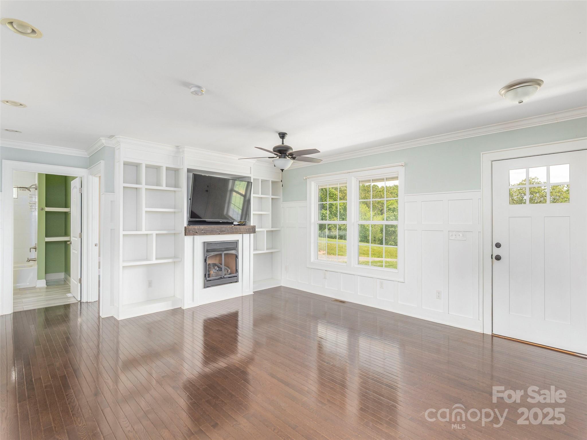 3355 Thickety Road Clyde, NC 28721 - Photo 3 of 33 a view of a livingroom with a flat screen tv wooden floor and window