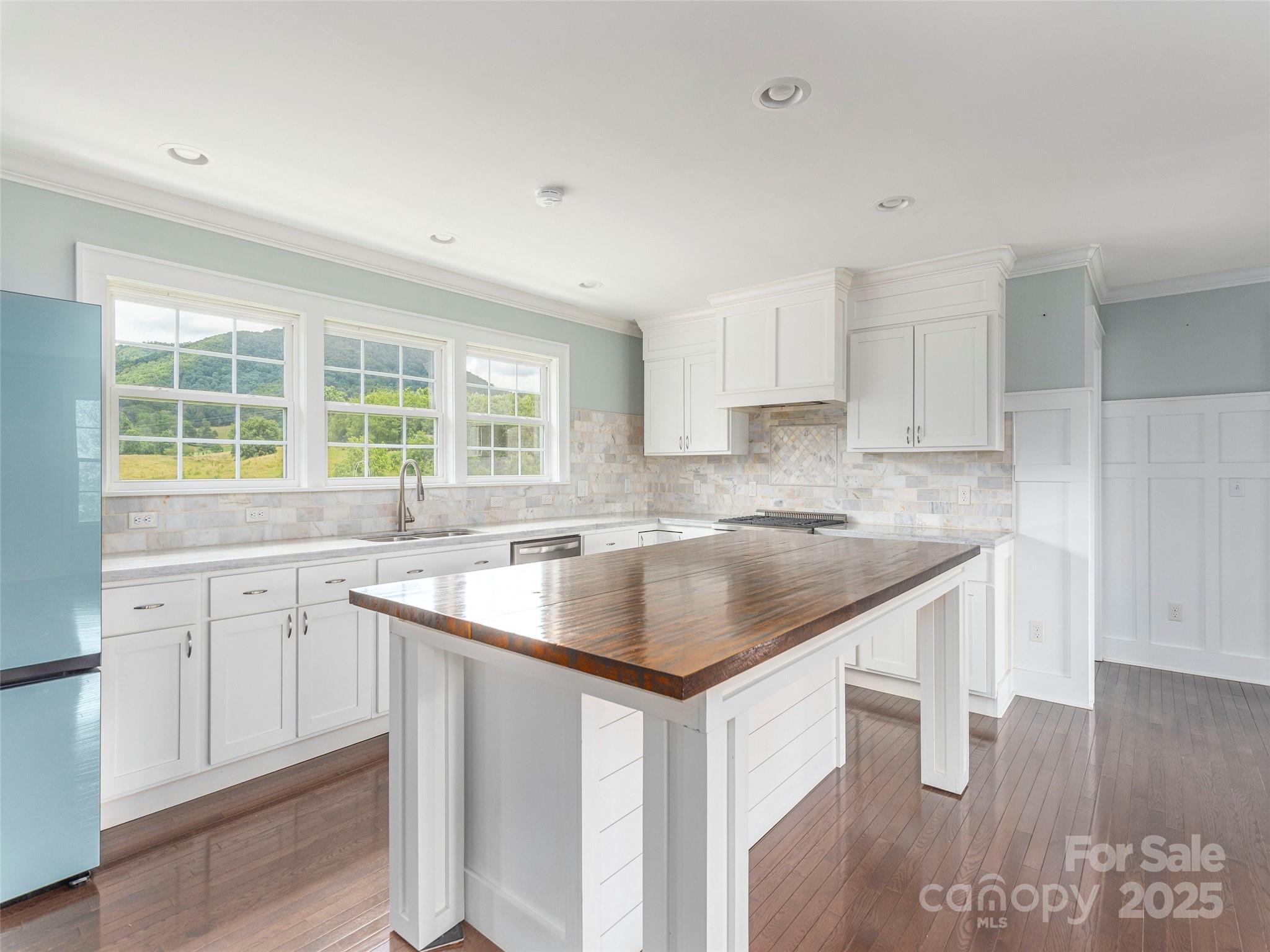 3355 Thickety Road Clyde, NC 28721 - Photo 8 of 33 a kitchen with a sink stove and cabinets