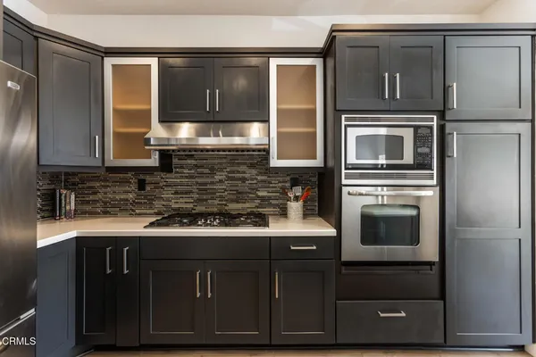 a kitchen with stainless steel appliances granite countertop a stove and a microwave