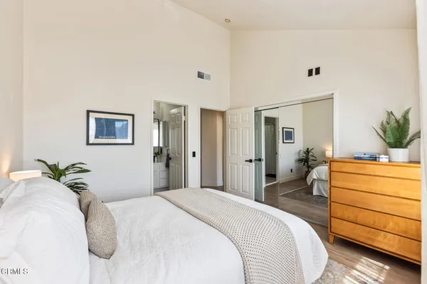 a bedroom with a bed and a dresser