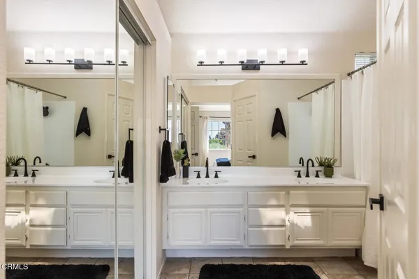 a bathroom with a sink vanity and mirror