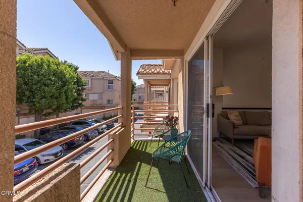 a balcony view with a outdoor seating