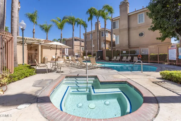 a view of a swimming pool with outdoor seating