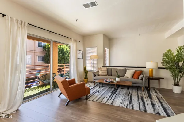 a living room with furniture and a large window