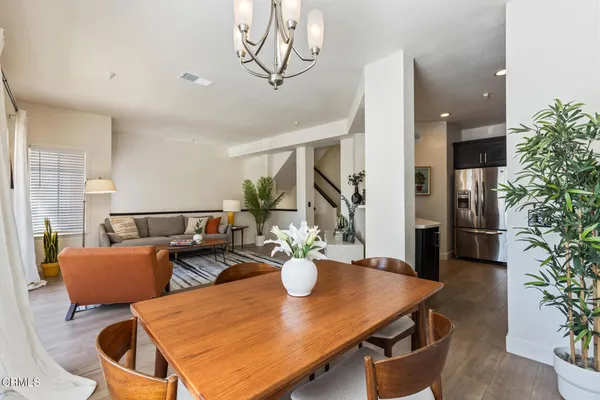 a view of a dining room with furniture and a potted plant