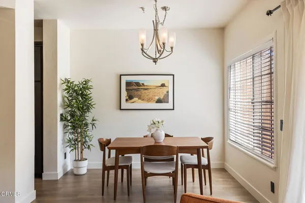 a view of a dining room with furniture window and wooden floor