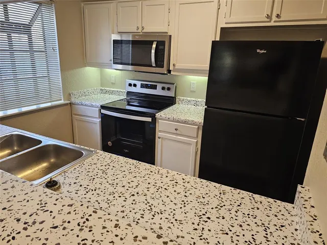 a kitchen with a sink and a refrigerator