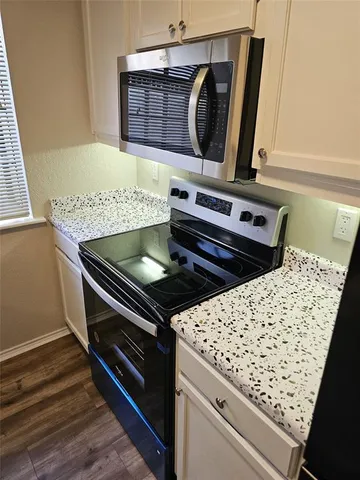 a stove top oven sitting inside of a kitchen