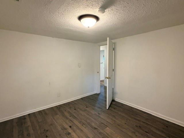 927 West Baker Street Denison, TX 75020 - Photo 11 of 14 an empty room with wooden floor and windows