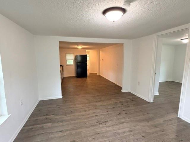 927 West Baker Street Denison, TX 75020 - Photo 2 of 14 an empty room with wooden floor and entrance