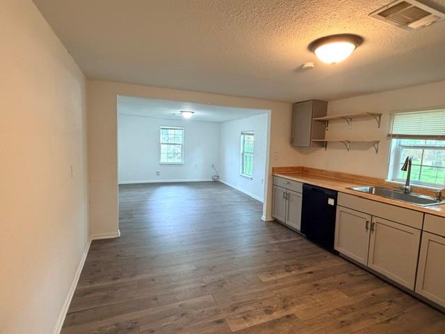 927 West Baker Street Denison, TX 75020 - Photo 4 of 14 a large kitchen with lot of counter space and wooden floor