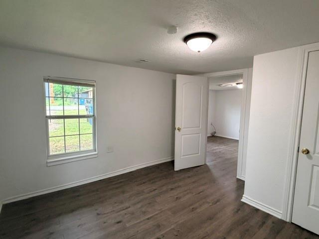 927 West Baker Street Denison, TX 75020 - Photo 8 of 14 an empty room with wooden floor and windows