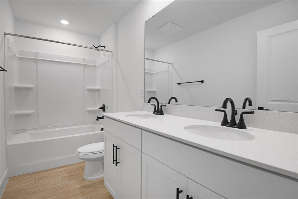 3725 Deer Rdg Drive Mount Dora, FL 32757 - Photo 17 of 23 a bathroom with a granite countertop sink a toilet and shower