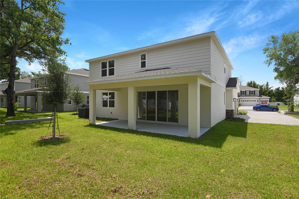 3725 Deer Rdg Drive Mount Dora, FL 32757 - Photo 23 of 23 a view of a house with a yard and a tree