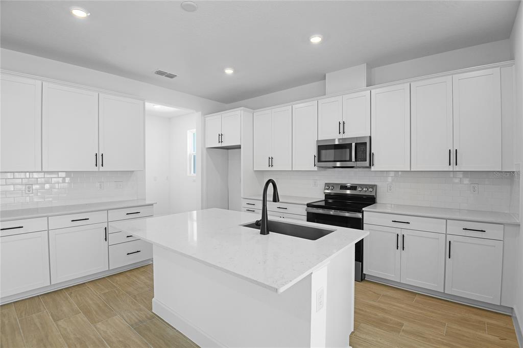 3725 Deer Rdg Drive Mount Dora, FL 32757 - Photo 4 of 23 a kitchen with white cabinets appliances and sink