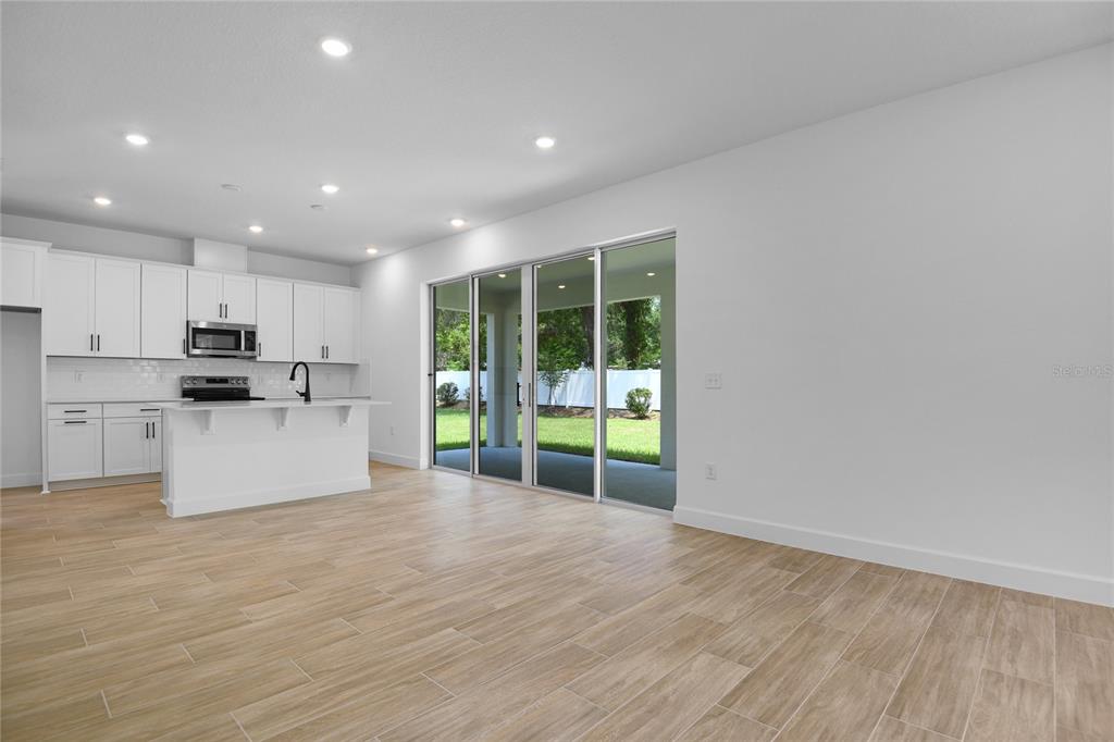3725 Deer Rdg Drive Mount Dora, FL 32757 - Photo 8 of 23 a view of kitchen with stainless steel appliances granite countertop a stove top oven a sink and a dishwasher with wooden floor