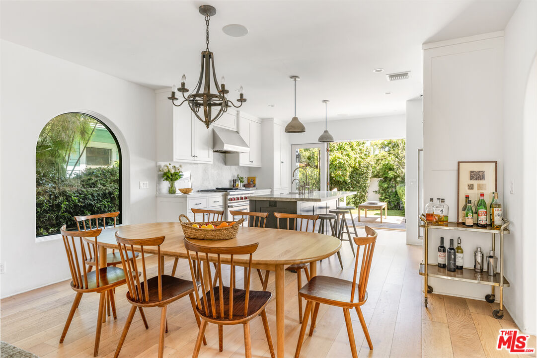 1616 Electric Avenue Venice, CA 90291 - Photo 11 of 35 a dining room with furniture a chandelier and wooden floor