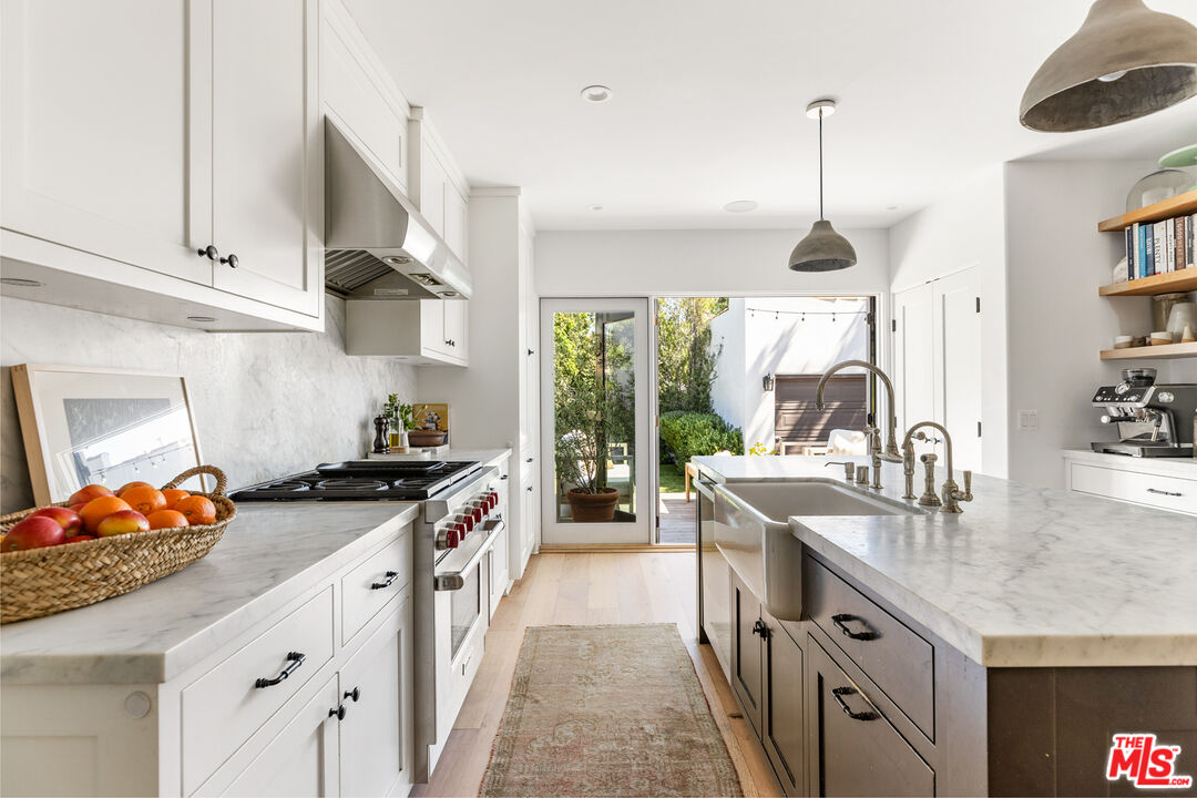 1616 Electric Avenue Venice, CA 90291 - Photo 13 of 35 a kitchen with stainless steel appliances granite countertop a stove a sink and a wooden floors