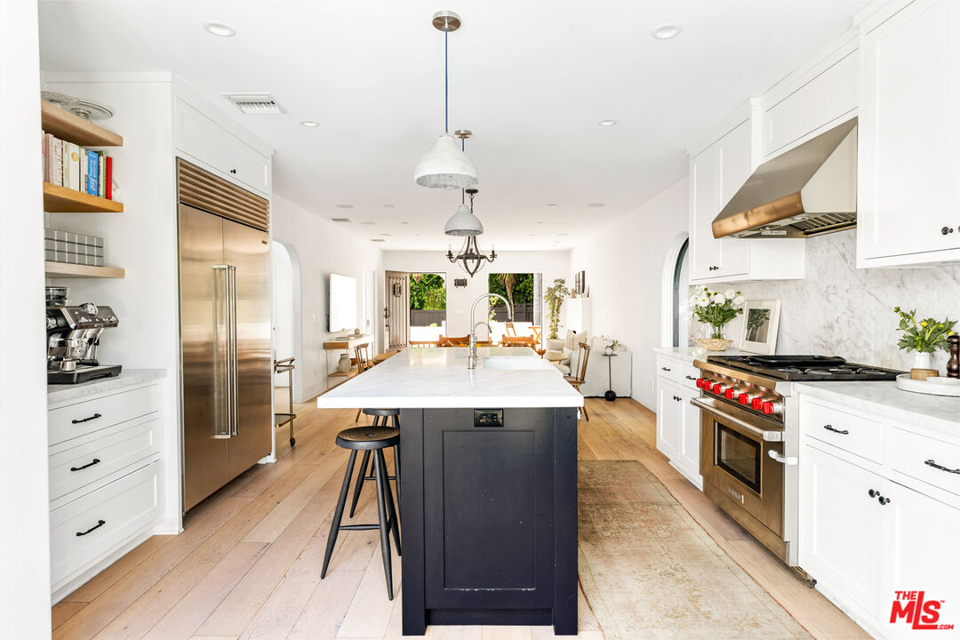1616 Electric Avenue Venice, CA 90291 - Photo 14 of 35 a kitchen with stainless steel appliances kitchen island a large counter top space a sink a stove and a refrigerator