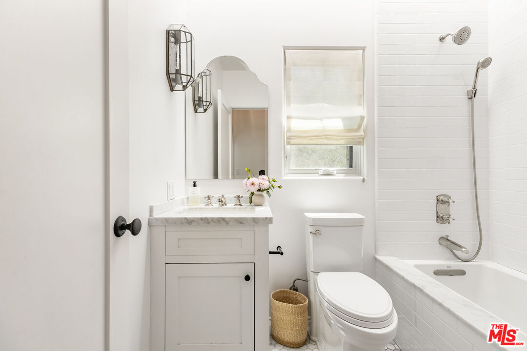 1616 Electric Avenue Venice, CA 90291 - Photo 16 of 35 a bathroom with a granite countertop toilet sink and mirror