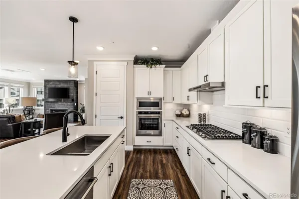 a kitchen with stove a sink and refrigerator