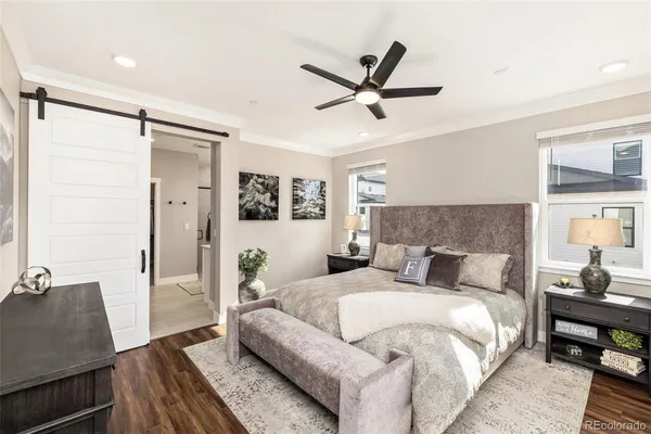 a large bedroom with a bed and wooden floor