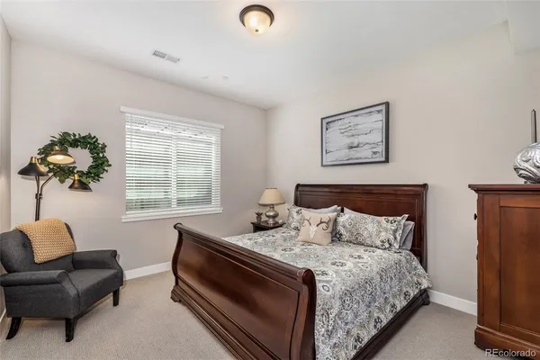 a bedroom with bed and a couch